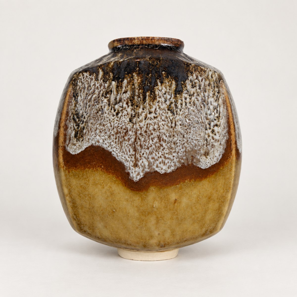 Slipcast form, amber glaze with a frothy white rim drip
