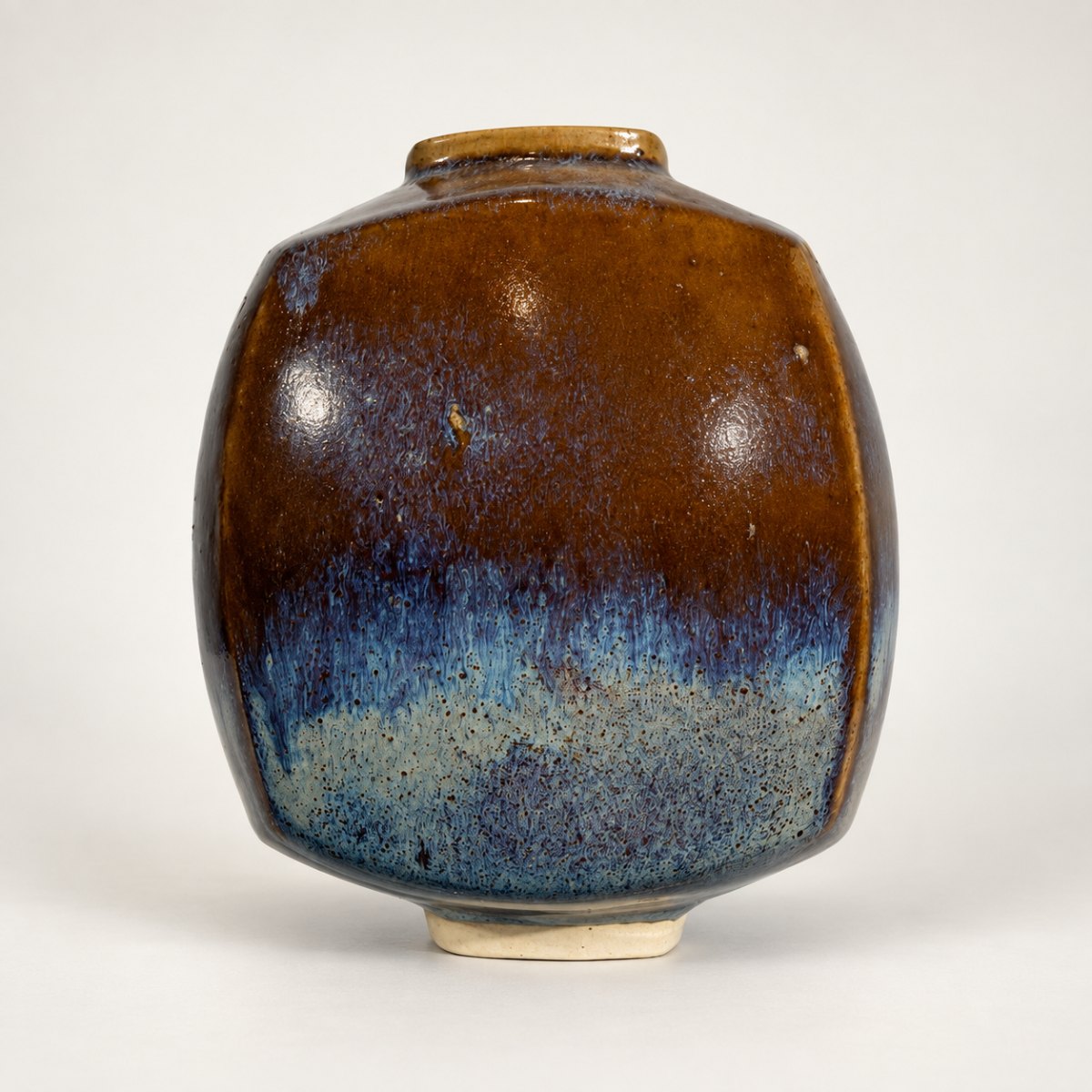 Slipcast form, chestnut brown breaking to blue-violet at the base